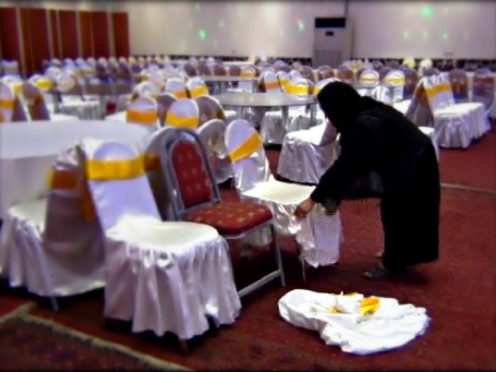 An Afghan woman works as a waitress at a wedding hall in Kabul.