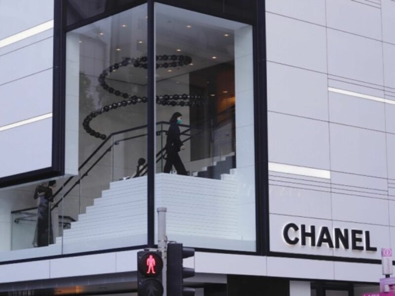 An assistant walking inside empty Chanel in Hong Kong.