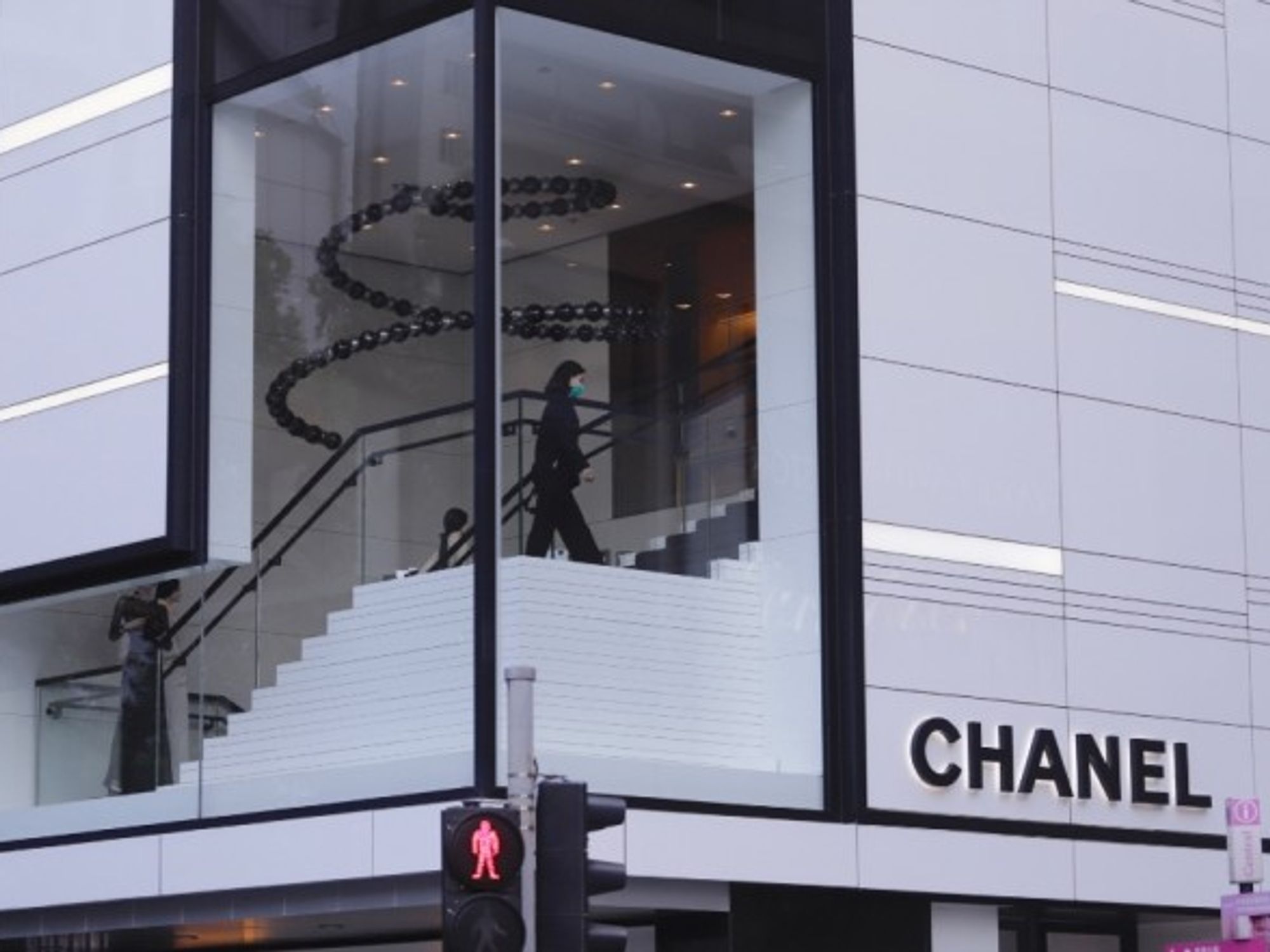 An assistant walking inside empty Chanel in Hong Kong.
