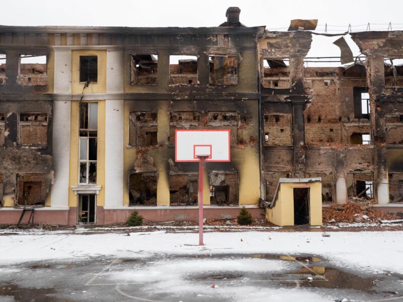 an empty basketball field and destroyed buildings in Kharkiv, Ukraine