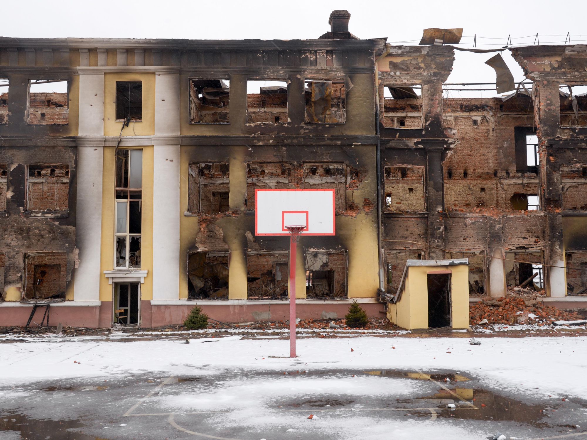 an empty basketball field and destroyed buildings in Kharkiv, Ukraine