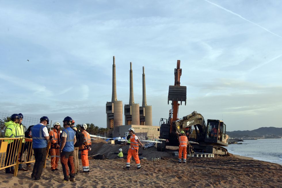 An excavator and workers at the arrival of the 2Africa submarine cable at the Barcelona Cable Landing Station, Oct. 25, 2022.