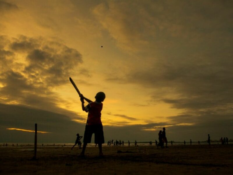 An Indian boy playing cricket.