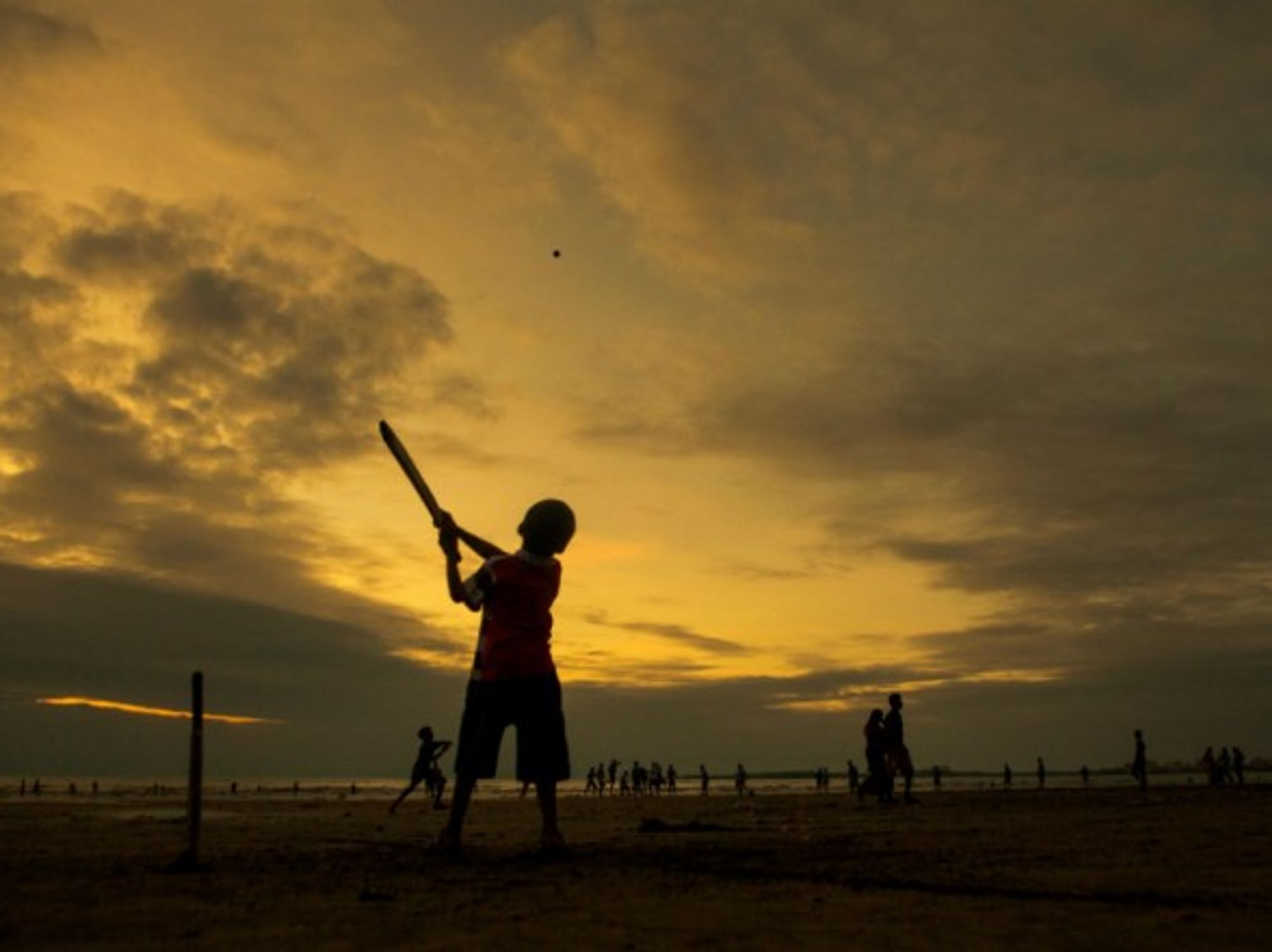 An Indian boy playing cricket.