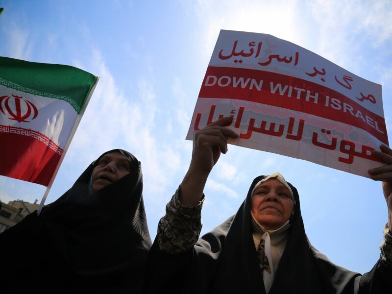 An Iranian veiled woman carries a placard written ''DOWN WITH ISRAEL'' during an anti-Israel rally in Tehran.
