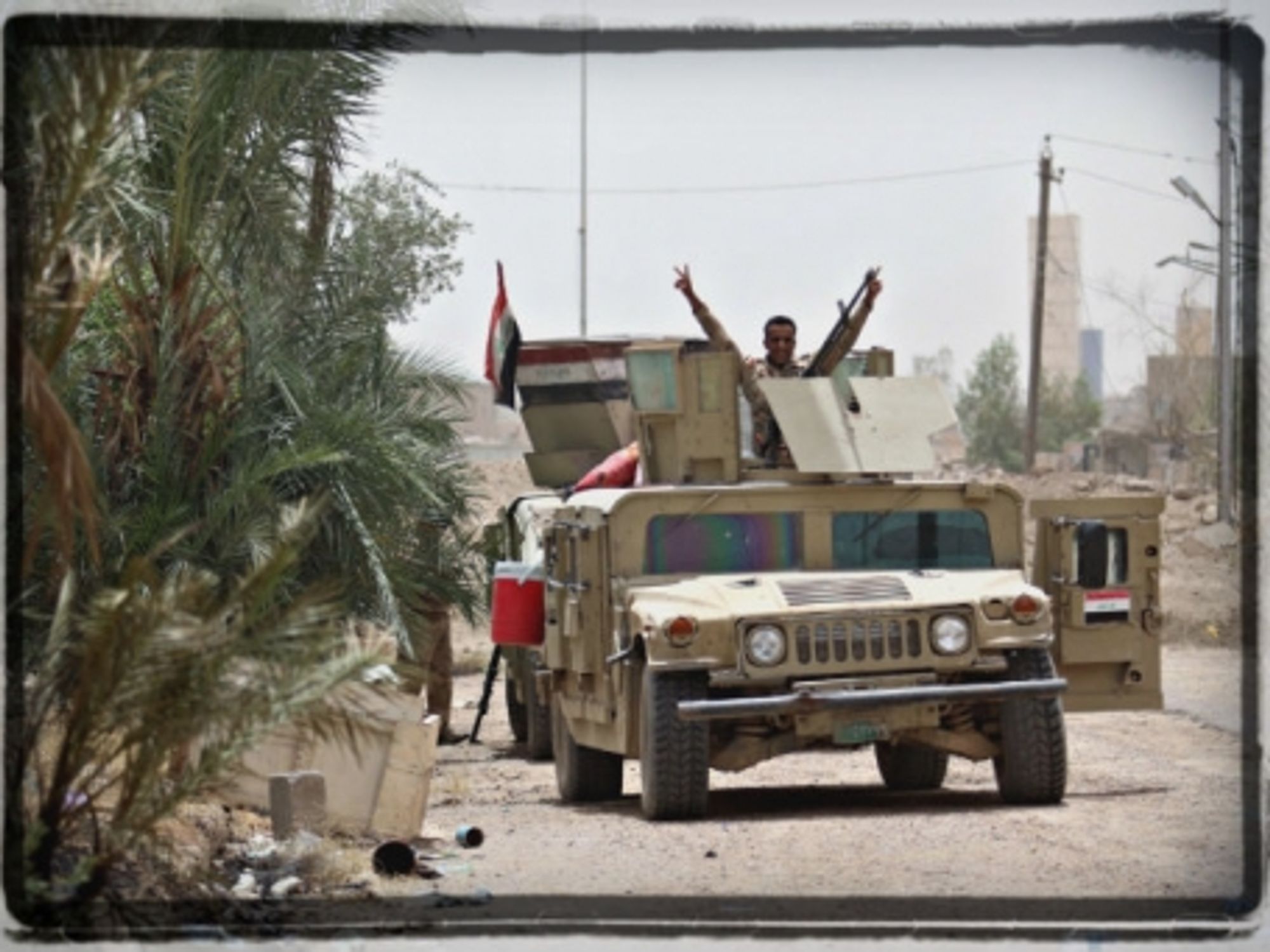 An Iraqi government soldier claims victory in Fallujah on June 20
