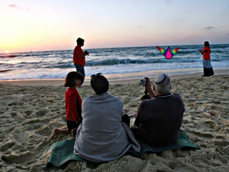 An Israeli family enjoying sunset on a beach
