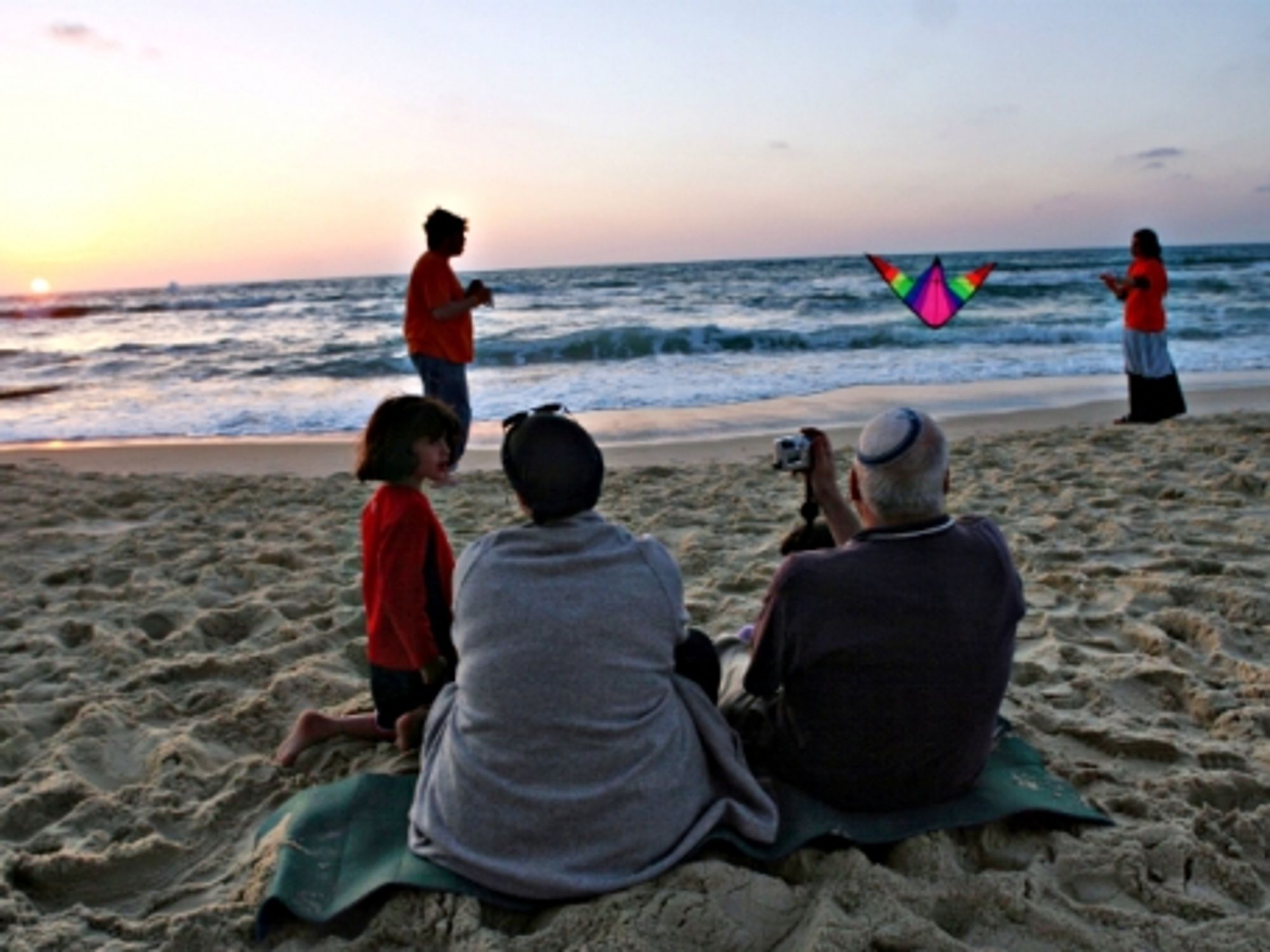 An Israeli family enjoying sunset on a beach