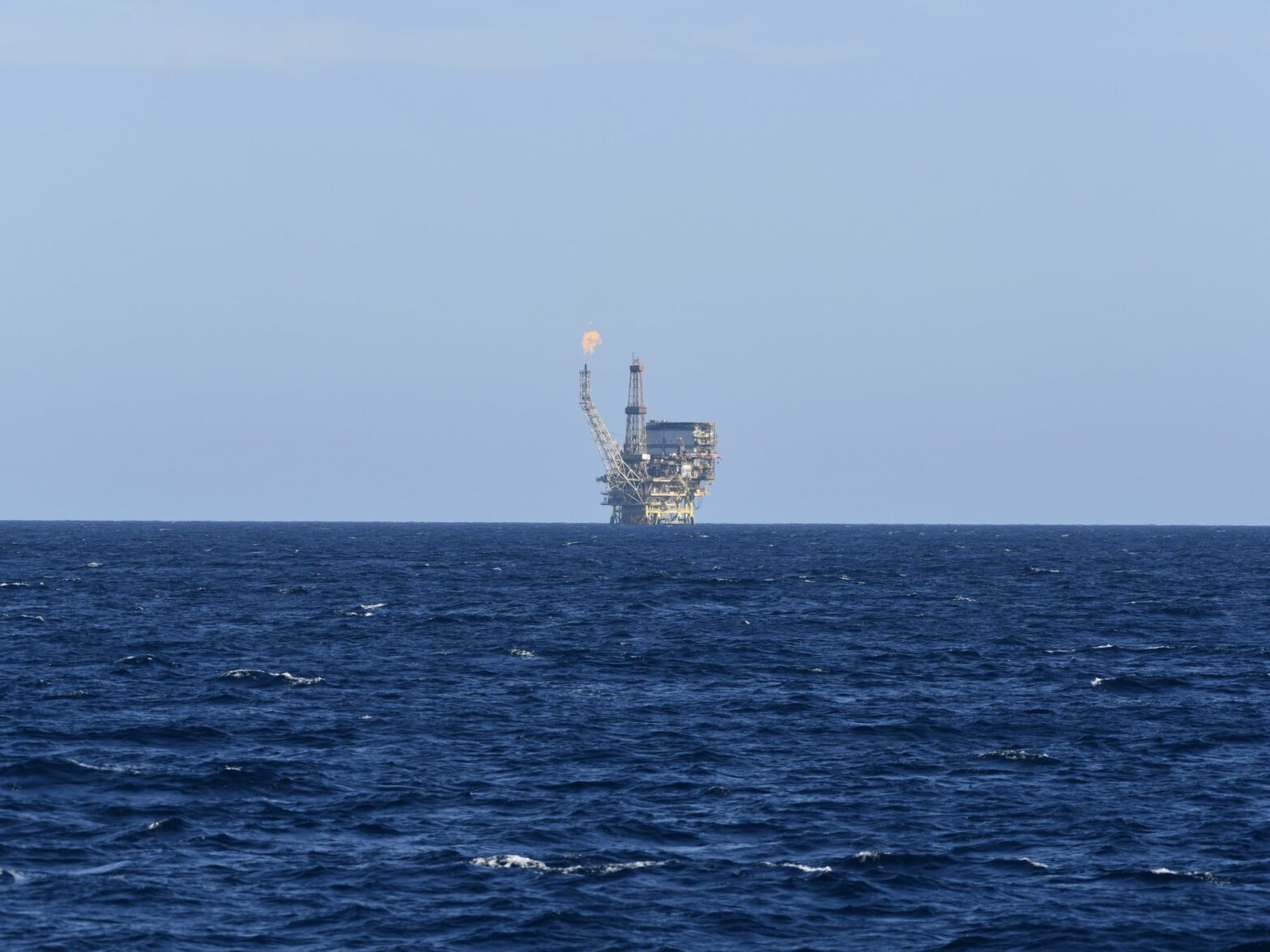 An oil field is seen in the distance of the Mediterranean Sea