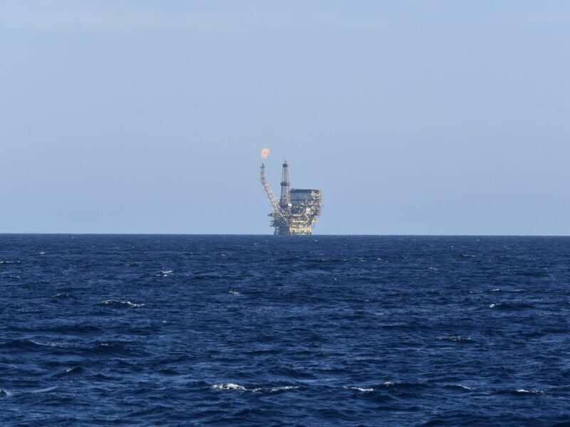 An oil field is seen in the distance of the Mediterranean Sea