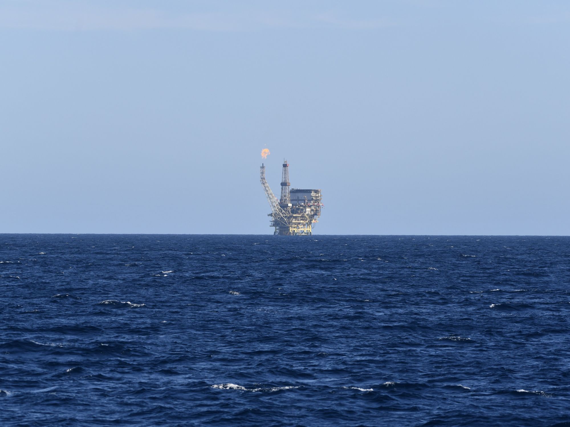 An oil field is seen in the distance of the Mediterranean Sea