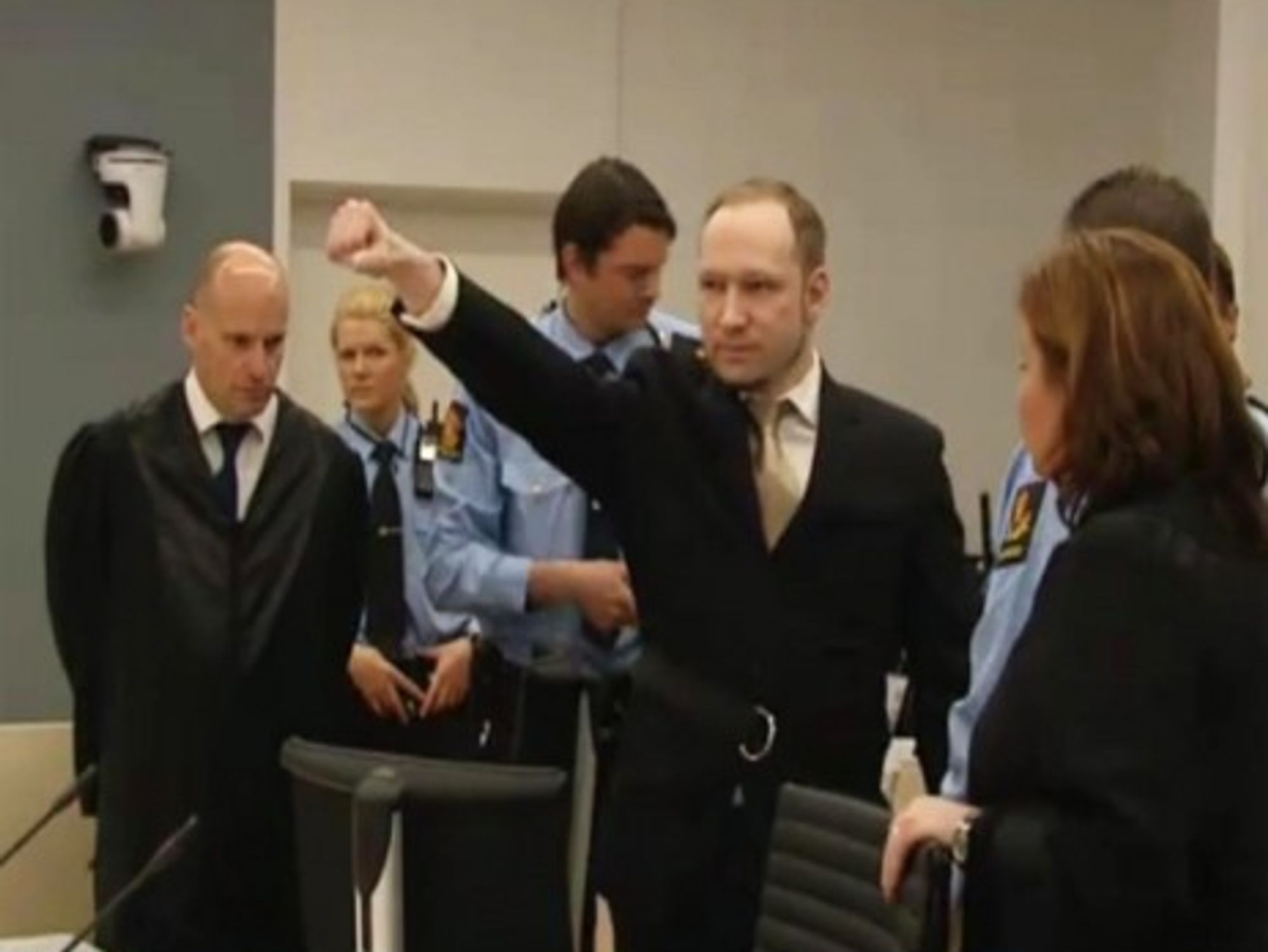 Anders Breivik's closed-fist salute at the start of his trial in Oslo (BBC News)