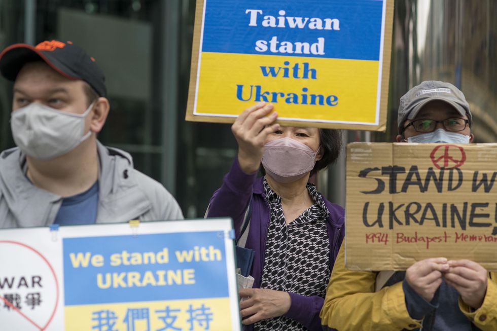 Anti-war protestors holding signs in Taipei, Taiwan, protesting against the Russian invasion of Ukraine