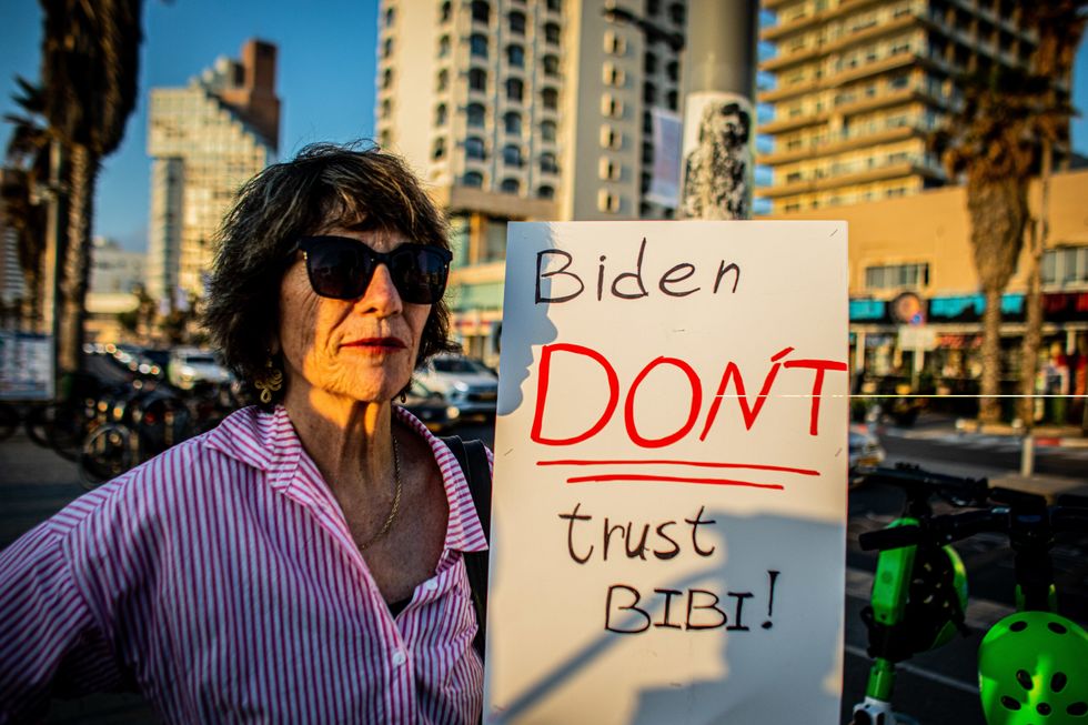 April 15, 2024, Tel Aviv, Israel: A protester holds a placard calling on U.S President Joe Biden not to trust Israeli Prime Minister Benjamin Netanyahu during a demonstration. Israel has vowed to ''exact a price'' from Iran after an unprecedented large-scale drone and missile attack over the weekend that escalated regional tensions stoked by the war in Gaza. (Credit Image: © Eyal Warshavsky/SOPA Images via ZUMA Press Wire)