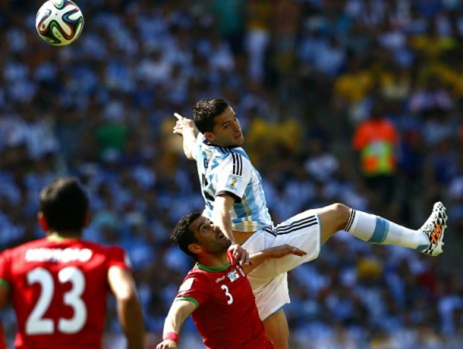 Argentina's Fernando Gago fights for the ball with Iran's Ehsan Hajsafi during a World Cup group match at the Estadio Mineirao Stadium in Belo Horizonte, Brazil, on June 21, 2014.
