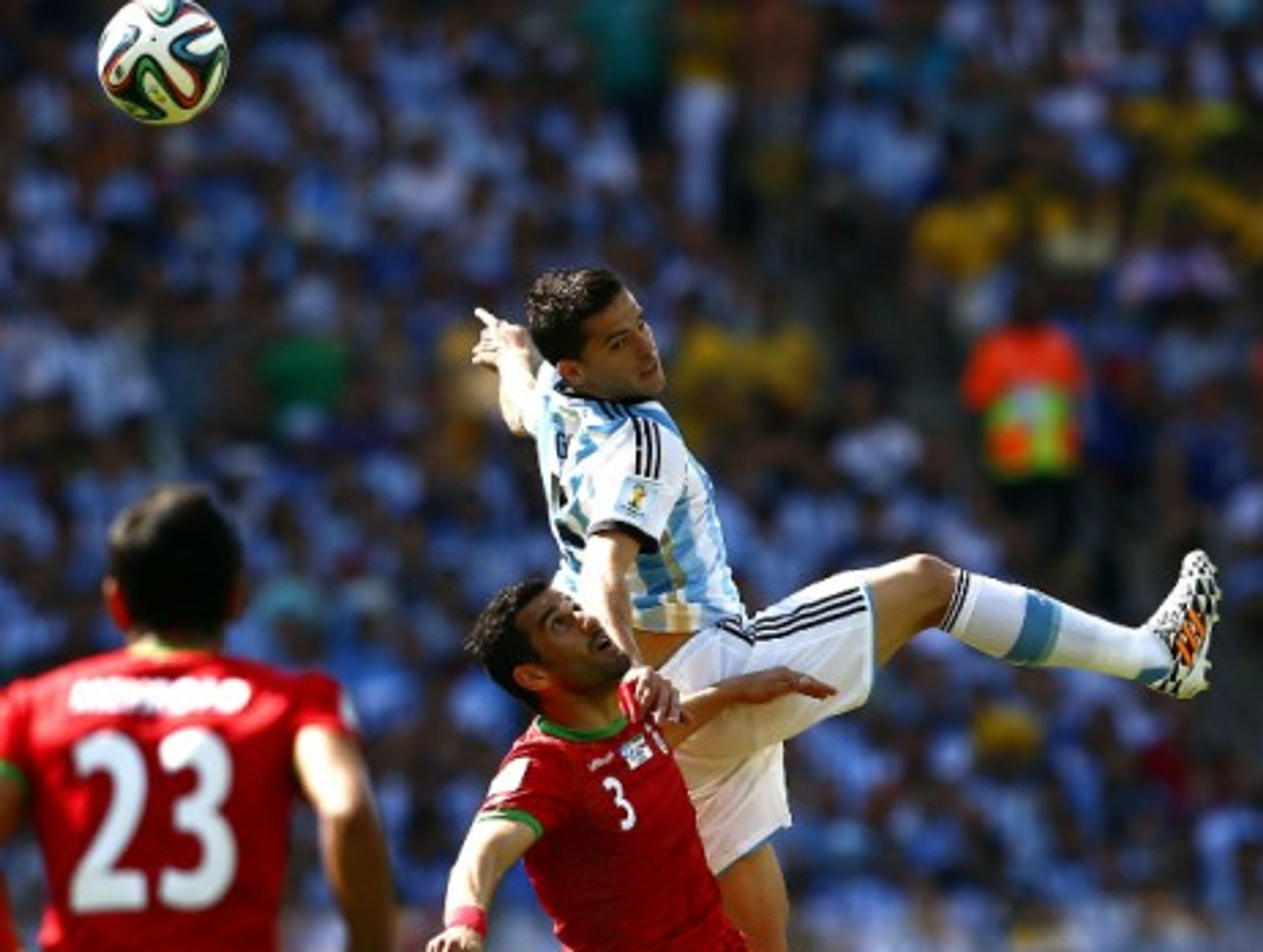 Argentina's Fernando Gago fights for the ball with Iran's Ehsan Hajsafi during a World Cup group match at the Estadio Mineirao Stadium in Belo Horizonte, Brazil, on June 21, 2014.