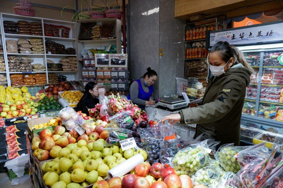 Ariuntuya Buuveibaatar browses for grapes at a store in Khan-Uul, Ulaanbaatar.