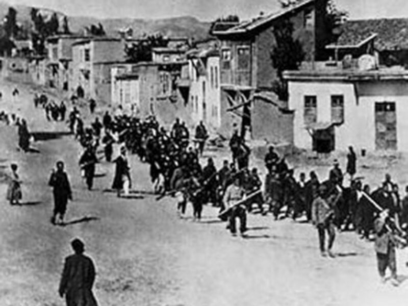 Armenian civilians are marched to a nearby prison in Mezireh by armed Ottoman soldiers (Wikipedia)