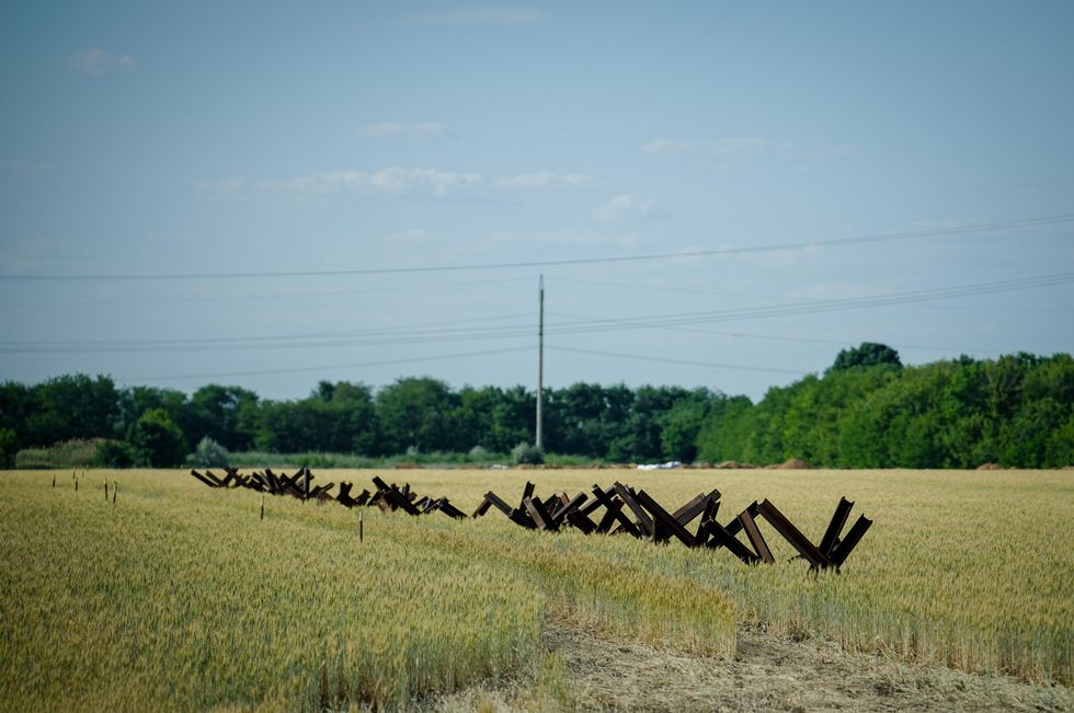 Armored barriers stand in a grain field between Odessa and the border with Moldova