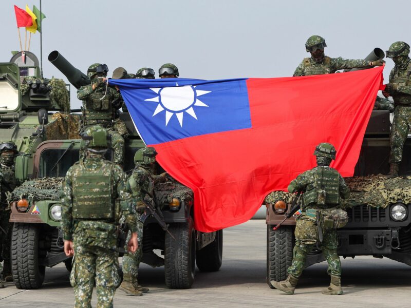 Army soldiers holding a Taiwanese flag during a military drill simulating defence operations against a possible Chinese PLA intrusion on Jan 11, 2023 in Kaohsiung.