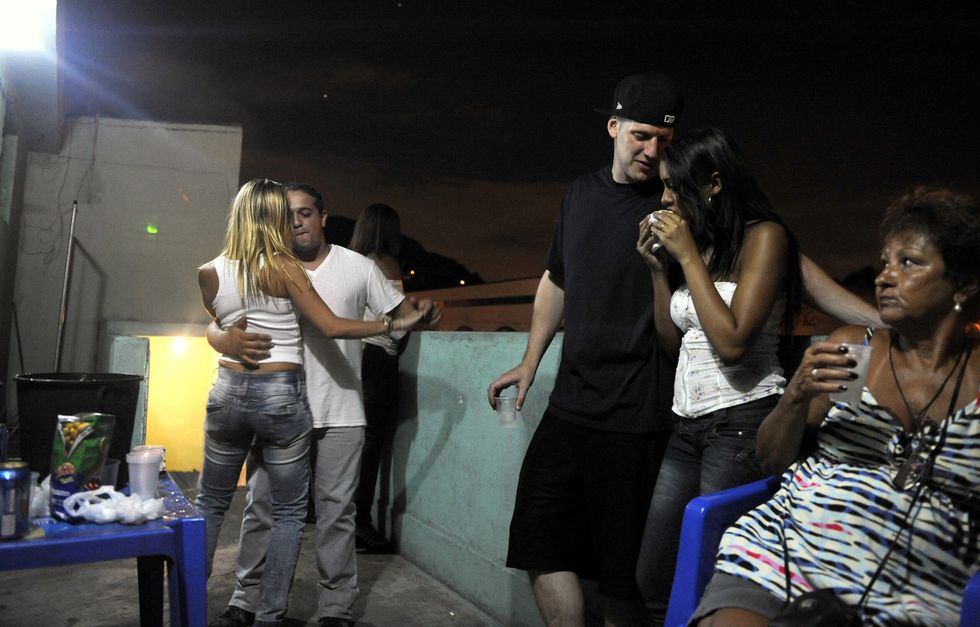 Artist ''Don Blanquito" waits outside a club before his performance with his girlfriend and friends, Rio de Janeiro, Brazil on March 4, 2012.