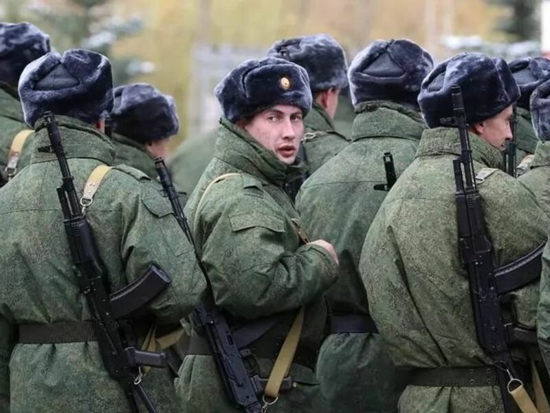 As russian soldiers march forward, one looks back