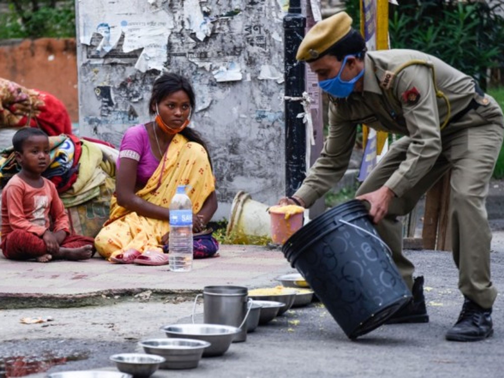 Assam Police distribute food to migrant people.