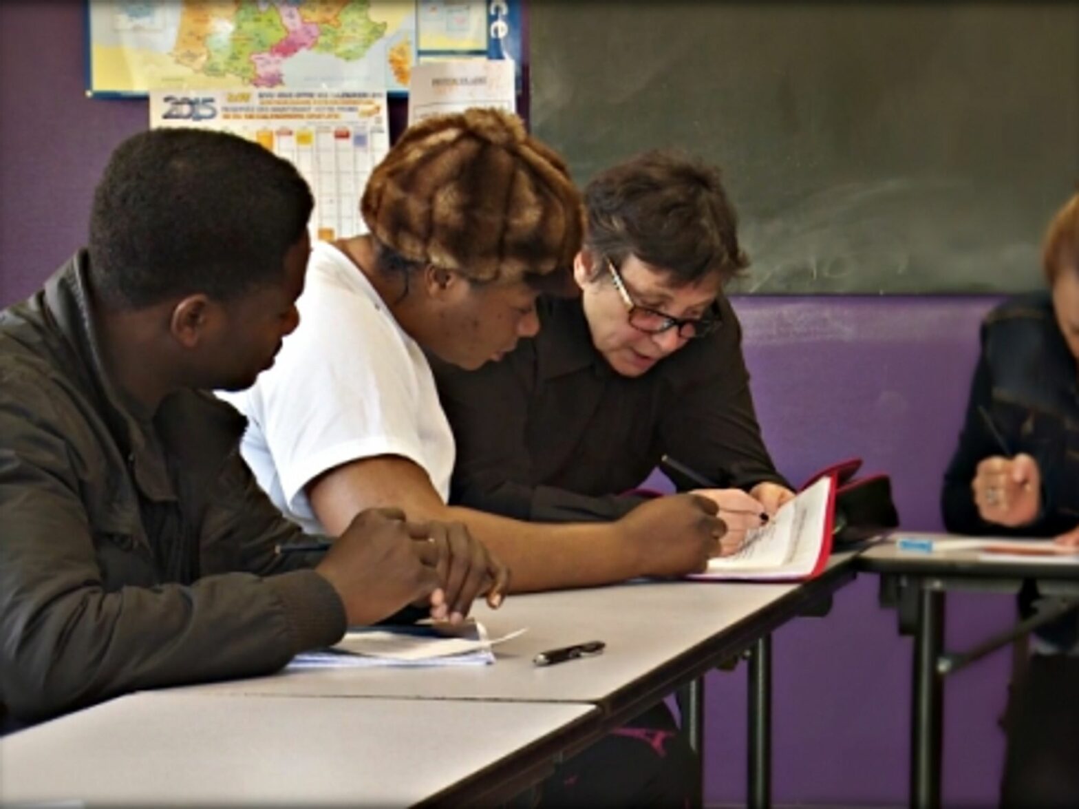 Asylum seekers in a classroom in Peyrelevade