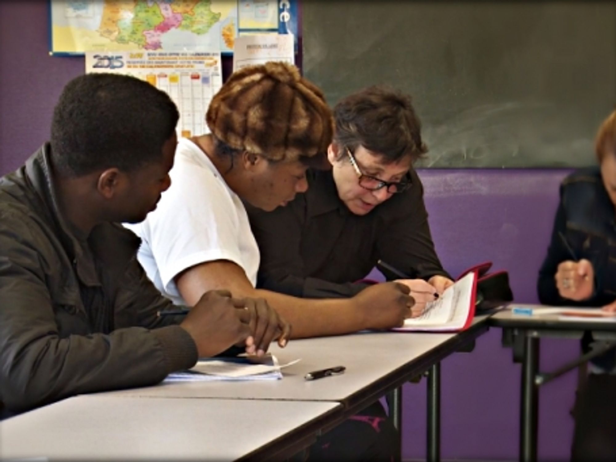 Asylum seekers in a classroom in Peyrelevade