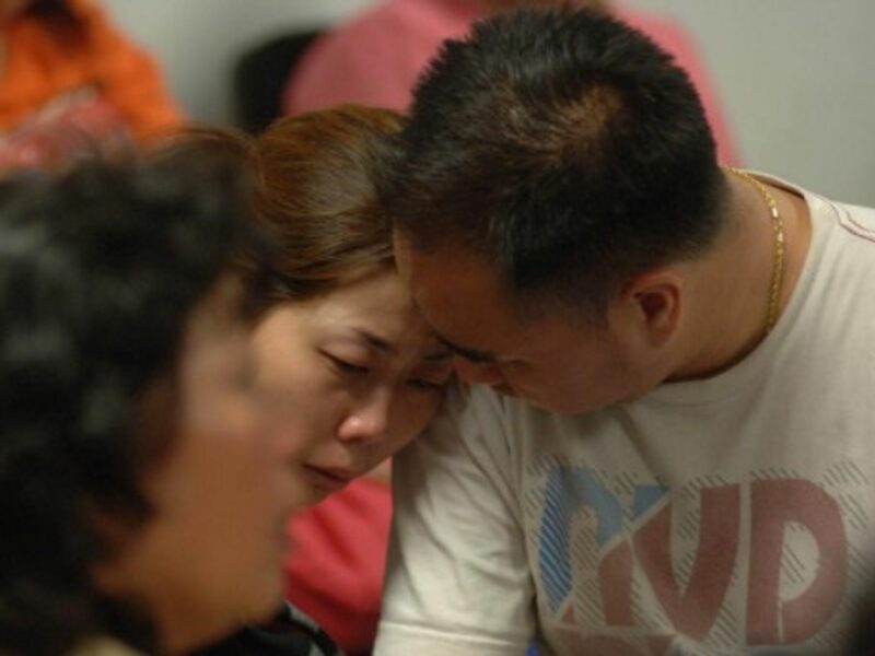 At Juanda Airport, relatives of the victims of the AirAsia plane crash