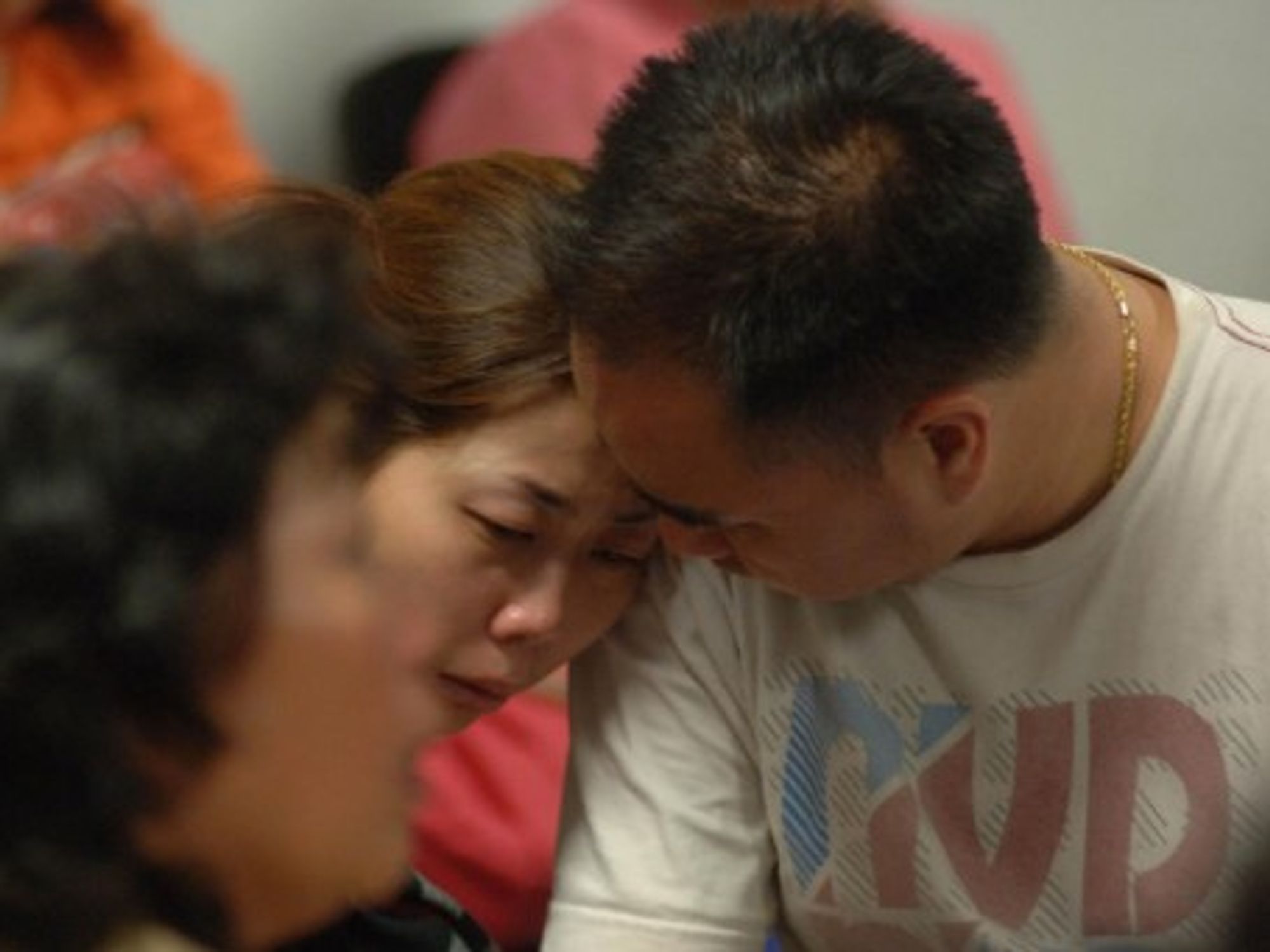 At Juanda Airport, relatives of the victims of the AirAsia plane crash