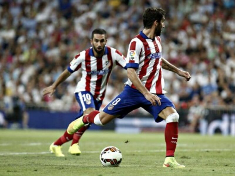 Atletico Madrid's Raul Garcia and Arda Turan