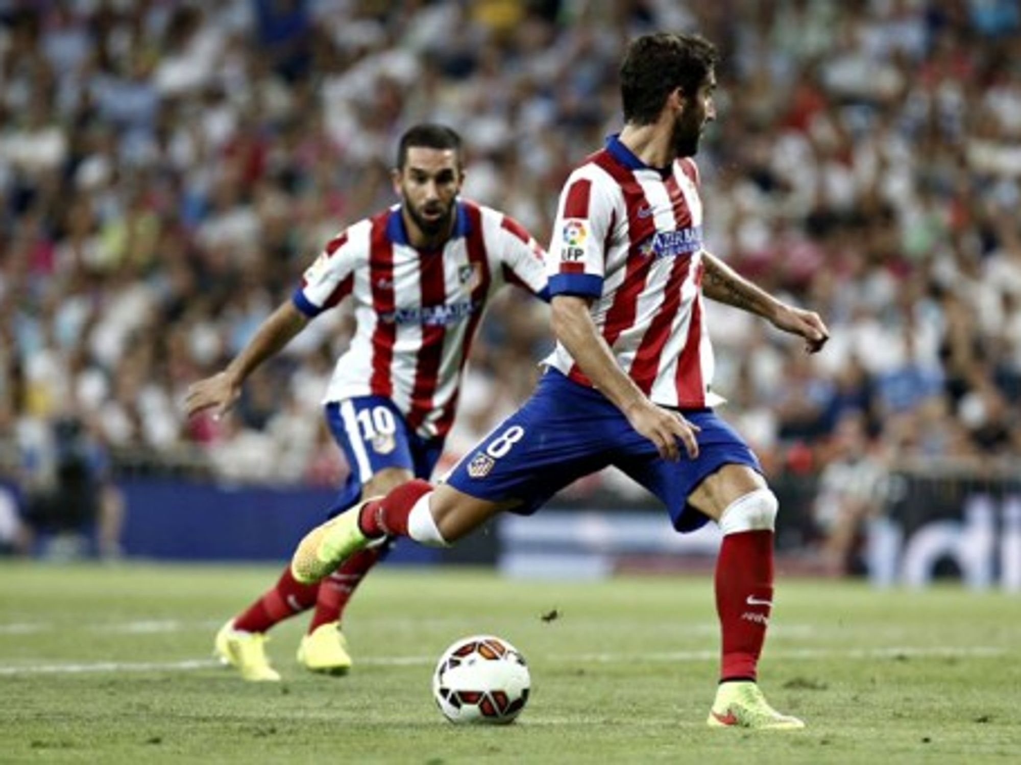 Atletico Madrid's Raul Garcia and Arda Turan