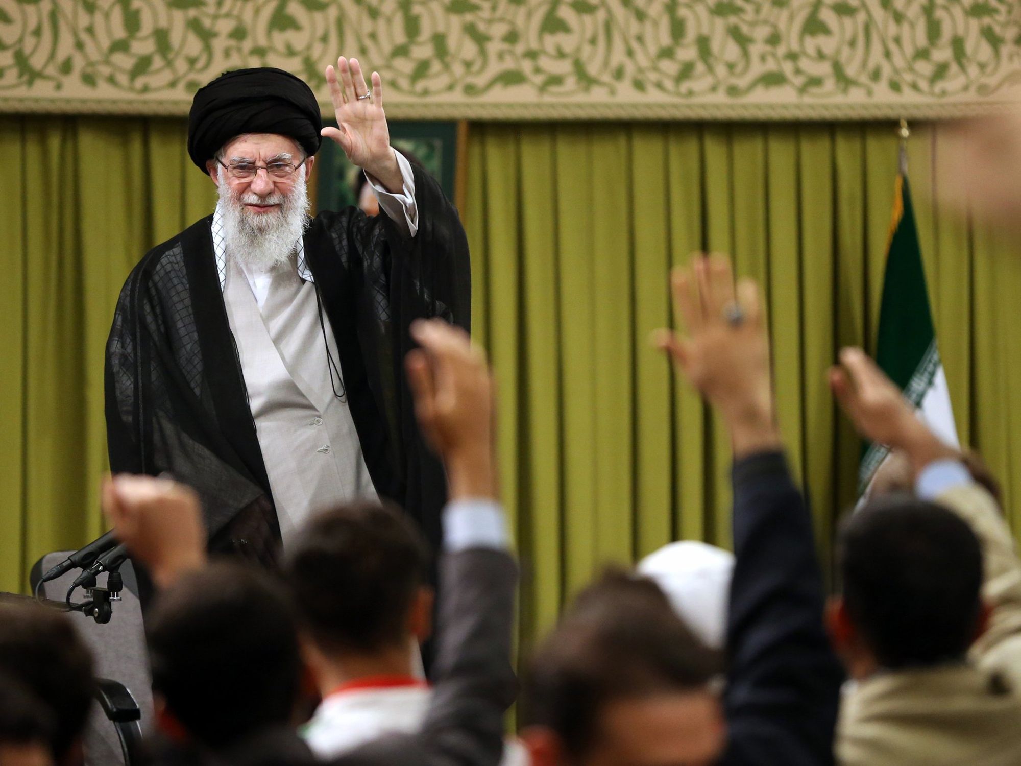 Ayatollah Ali Khamenei greets students during a Tehran meeting