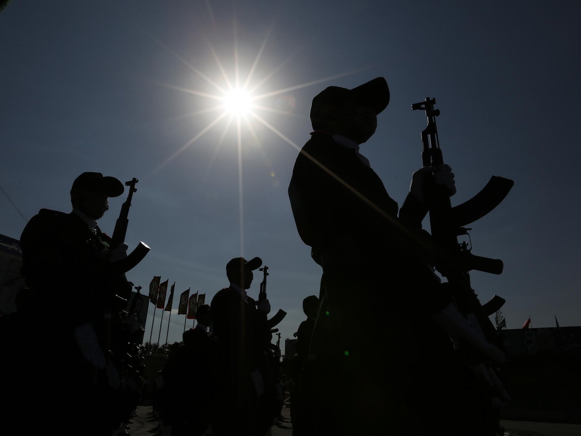 Backlit photo of Iranian soldiers marching in Tehran on October 3, 2021