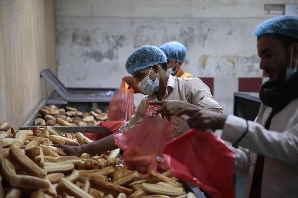 Bakers in Yemen put bread into plastic bags at a baker Wheat prices have risen sharply on world markets in the wake of the Russian attack on Ukraine, putting more pressure on the already dire situation in Yemen, which imports 90 per cent of its wheat.