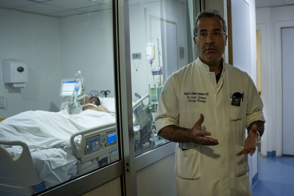 Beirut, Lebanon: Plastic surgeon Dr Ziad Sleiman explains the condition of a burned patient in the corridor of the Lebanese Geitawi hospital. The war between Israel and Hezbollah continues unabated. More than 1.2 million people have been forced to flee their homes and more than 1,400 people have been killed.