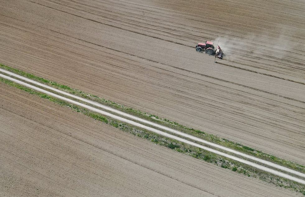 Bird's eye view photo of a farmer drilling seed on a field in the Oder-Spree district of East Brandenburg.
