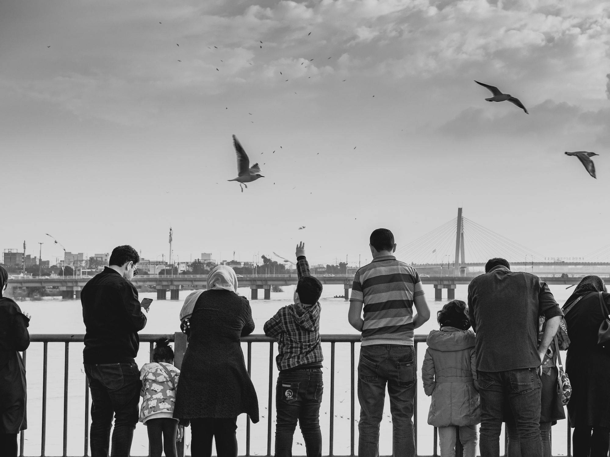 Black and white image of people on a bridge in Ahvaz, Iran.