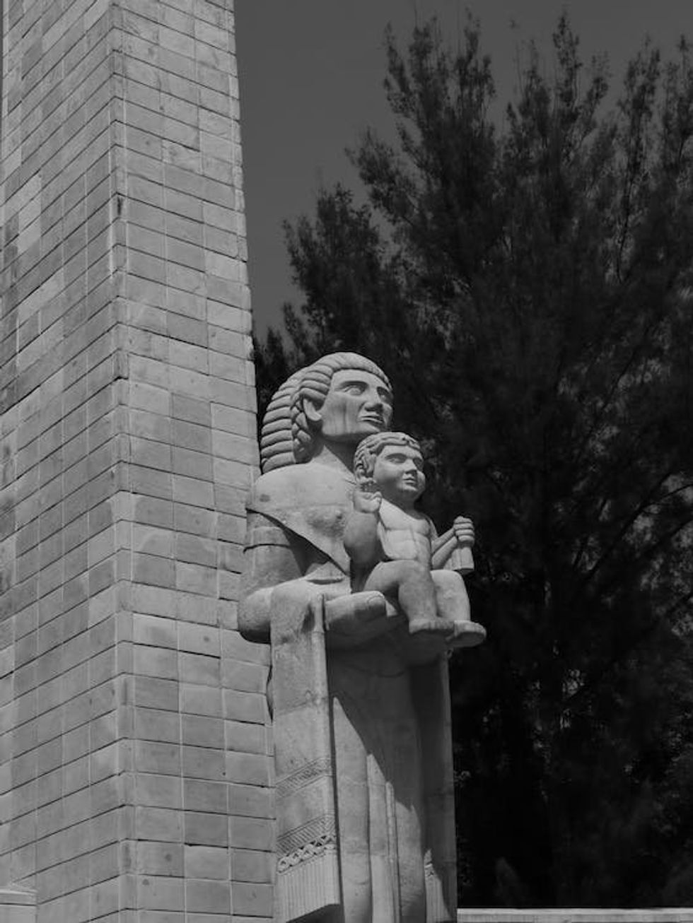 Black-and-white photo of a ​statue of a mother and her child in Mexico City