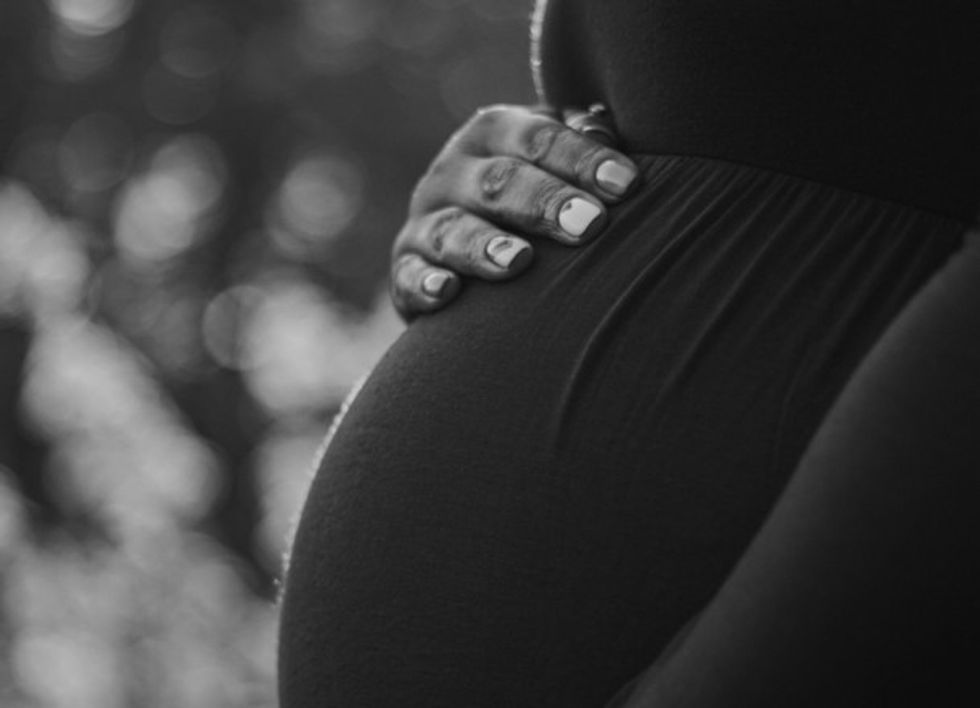 Black and white photo of a pregnant woman