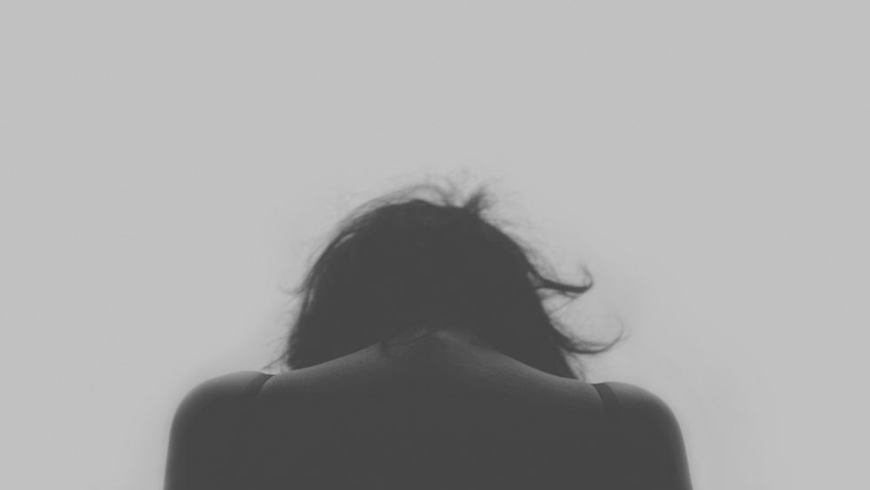 Black and white photo showing a woman from behind.