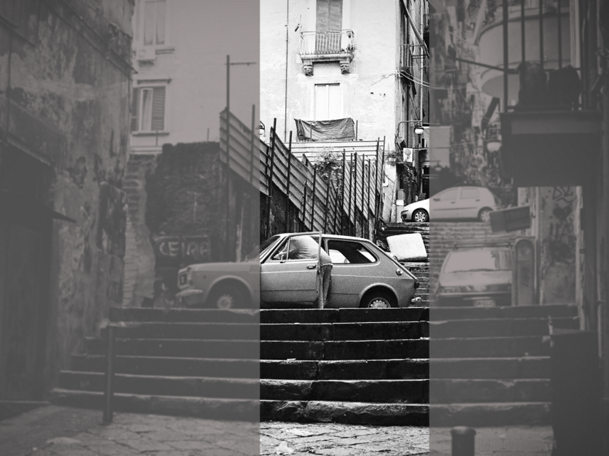 Black-and-whote photo of a man stepping in an old car in a Naples street