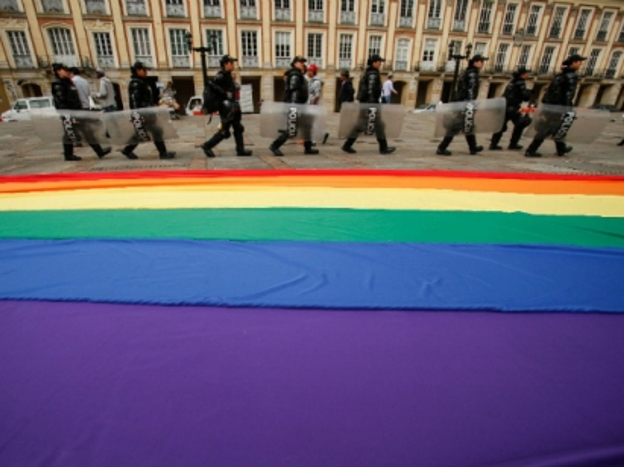 Bogota police officers stand guard outside the Colombian Congress, where lawmakers were voting on a proposed bill to legalize same-sex marriage in the country, on April 23, 2013.