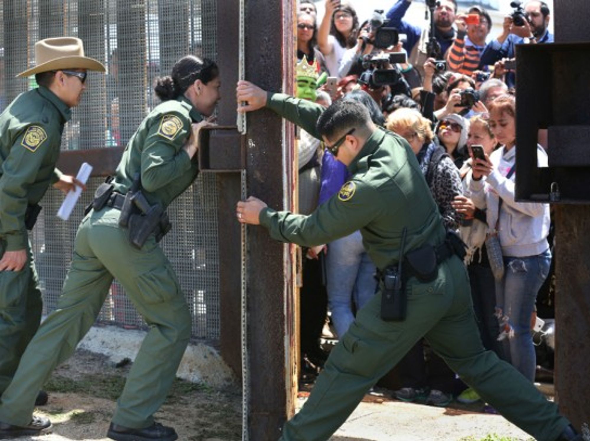 Border Patrol agents closing the Door of Hope between Tijuana and San Diego