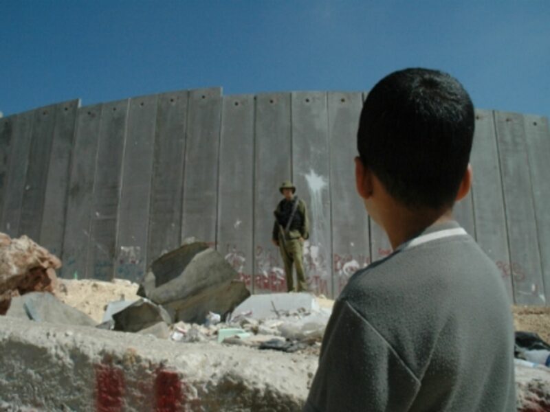 Boy and a soldier at the West Bank wall