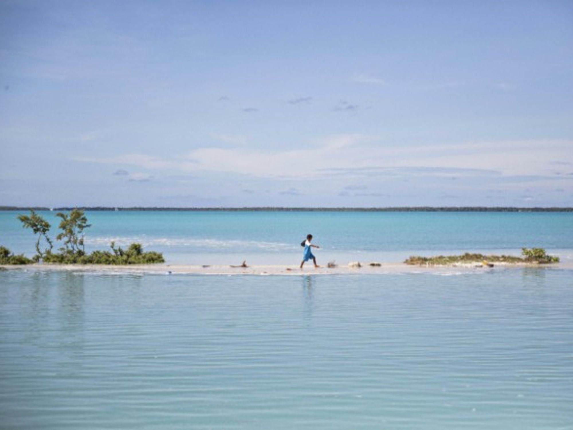 Boy walking to school in Aberao, Kiribati