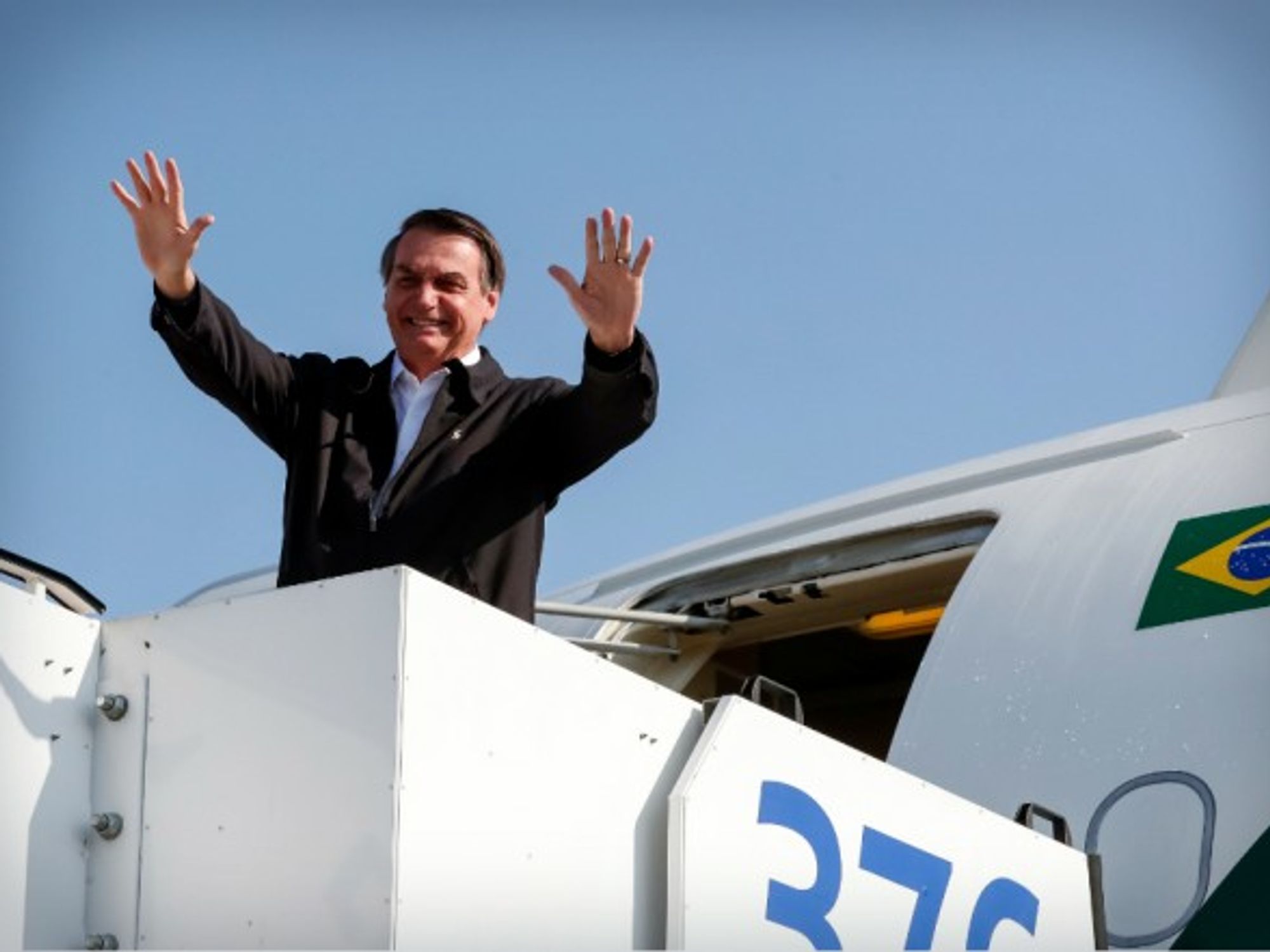 Brazil's President Jair Bolsonaro waving to the crowd as he leaves Israel