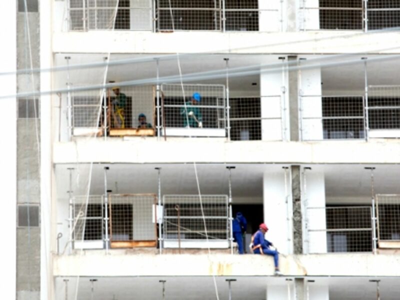 Builders work on the construction site of the Olympic and Paralympic Village in Rio de Janeiro, Brazil, 2015