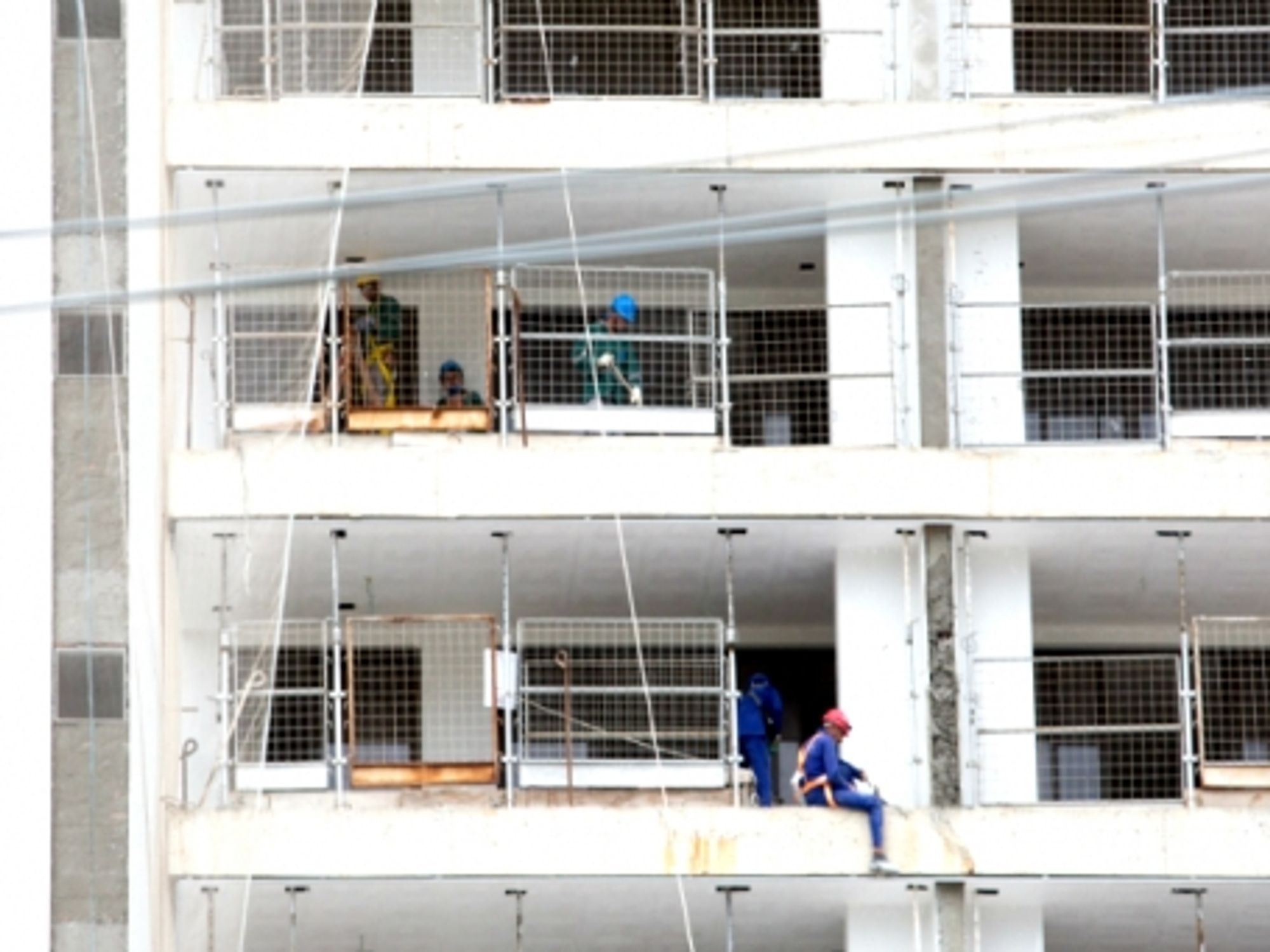 Builders work on the construction site of the Olympic and Paralympic Village in Rio de Janeiro, Brazil, 2015